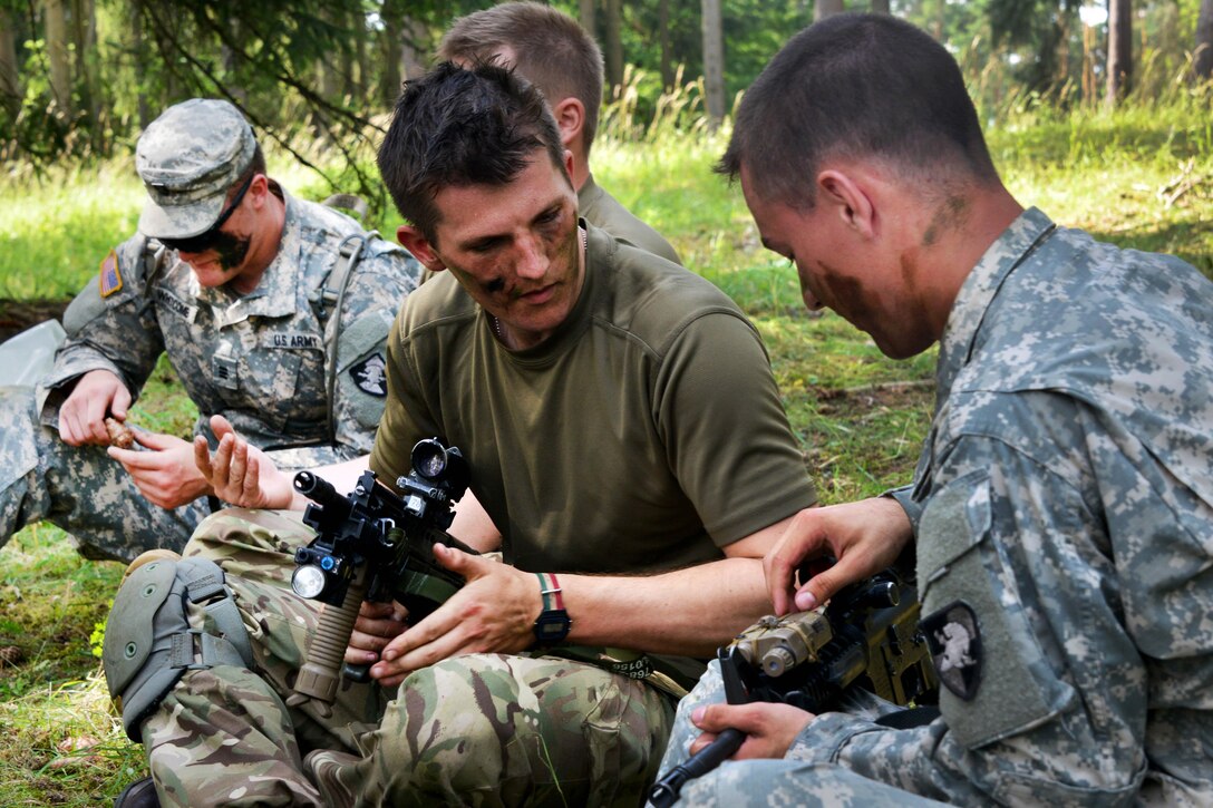 U.S. Army and British army cadet’s talk weapons maintenance and techniques after participating in a squad level movement during Exercise Dynamic Victory at the Grafenwoehr Training Area, Germany, July 11, 2016. Army photo by Gertrud Zach 