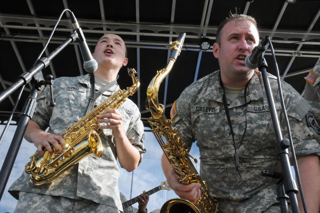 Spc. Andrew Duong and Sgt. Arthur Guillette of the U.S. Army Reserve's 319th Army Band stationed at Fort Totten, New York, engage the crowd during a performance July 15 at Joint Base McGuire-Dix-Lakehurst, New Jersey. The band was opening for Kool And The Gang as part of the JBMDL Summer Concert Series.