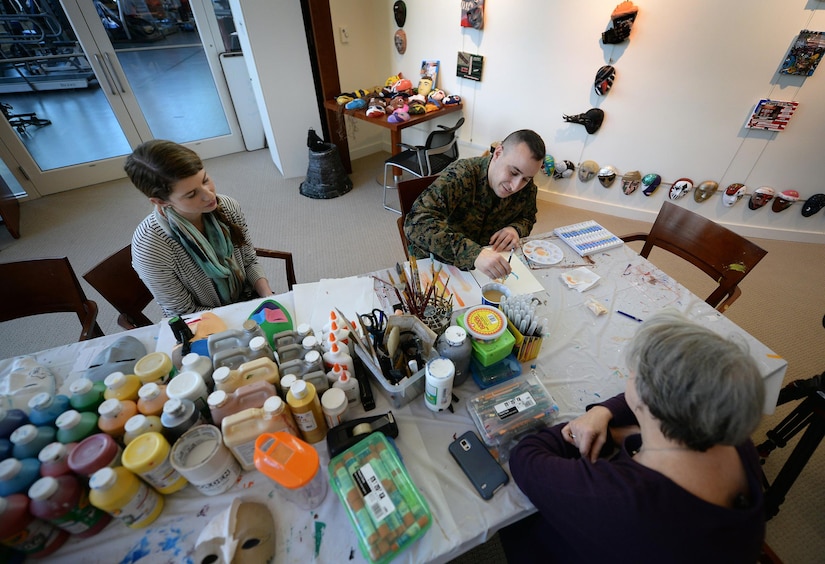 Marine Corps Staff Sgt. Anthony Mannino performs art therapy with guidance from Adrienne Stamper, art therapy intern as part of his traumatic brain injury treatment and recovery at the National Intrepid Center of Excellence in Bethesda, Md., March 1, 2016. DoD photo by Marvin Lynchard