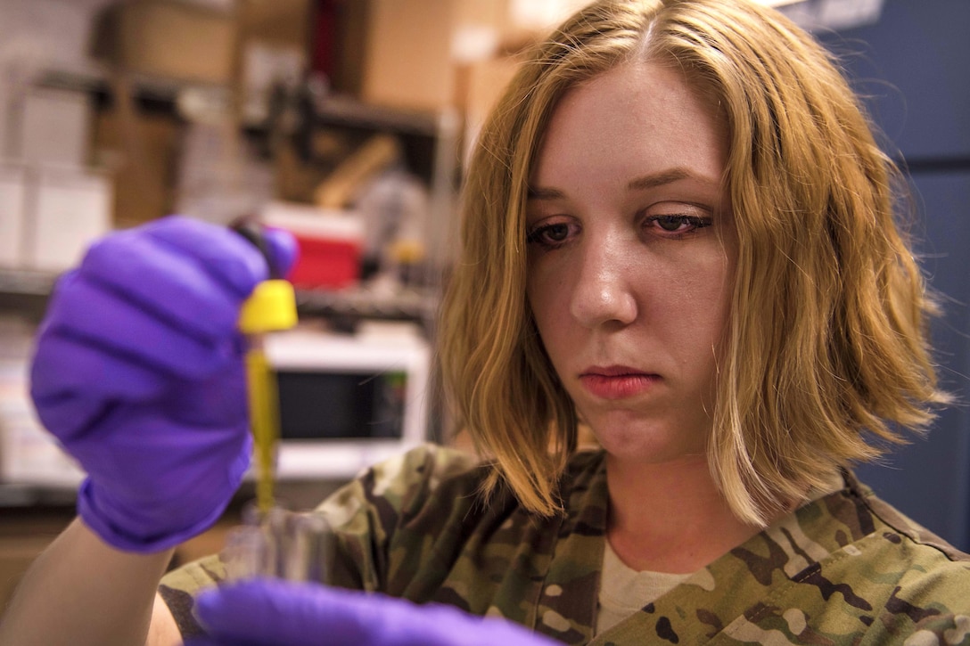 Air Force Staff Sgt. Megan Montagnino drops antibodies into a patient's red blood cells in the Craig Joint Theater Hospital at Bagram Airfield, Afghanistan, July 8, 2016. Montagnino mixed antibodies with a sample of a patient’s blood to verify the blood type. Air Force photo by Senior Airman Justyn M. Freeman
