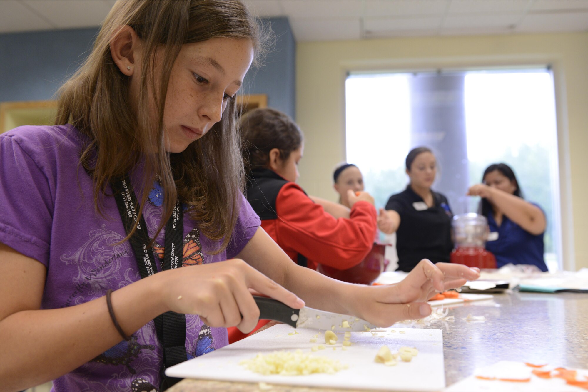 Elizabeth Lewis, 10, minces garlic at the Two Rivers Cooking Camp hosted at Two Rivers Youth Center, Joint Base Elmendorf-Richardson, Alaska, July 11, 2016. Ten youth center members participated in the Cooking Camp. (U.S. Air Force photo by Airman 1st Class Javier Alvarez)