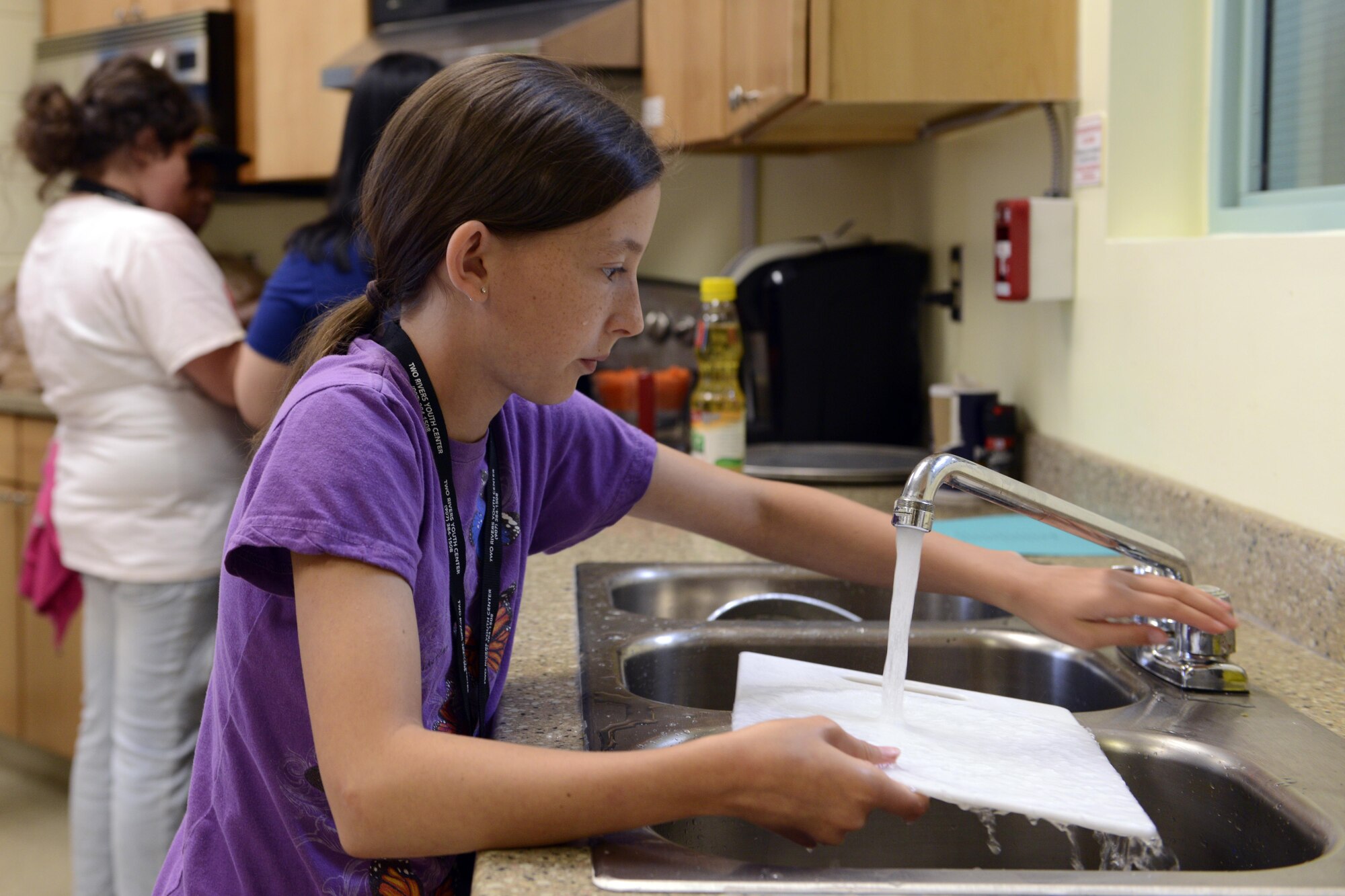 Elizabeth Lewis, 10, washes a cutting board at the Two Rivers Cooking Camp hosted at Two Rivers Youth Center, Joint Base Elmendorf-Richardson, Alaska, July 11, 2016. The cooking camp is offered every summer at Two Rivers. (U.S. Air Force photo by Airman 1st Class Javier Alvarez)