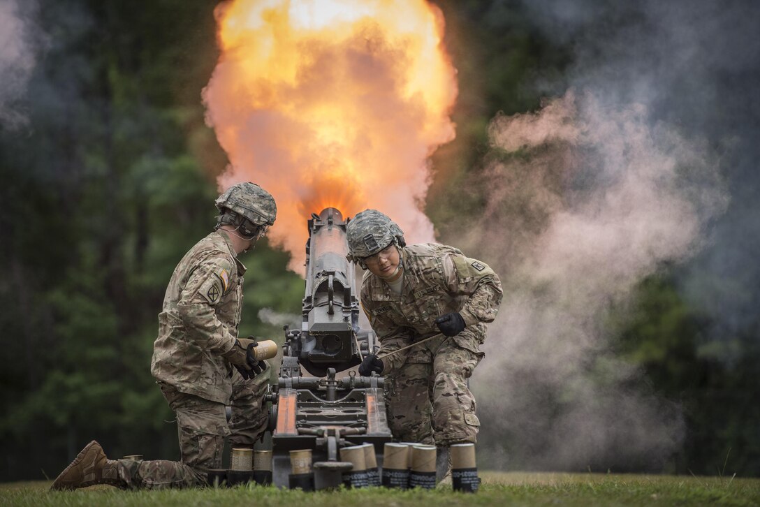 FIRE! U.S. Army Sgt. Ryan Skelton (left) of Denver, Co., and Staff Sgt. Elvis Servellon of Omaha, Neb. - both with the Fort Jackson Salute Battery - fire an M116 Howitzer during a retirement ceremony for Brig. Gen. Janice M. Haigler, deputy commanding general of the 335th Signal Command (Theater), at Fort Jackson, S.C., July 16, 2016. (U.S. Army photo by Staff Sgt. Ken Scar)