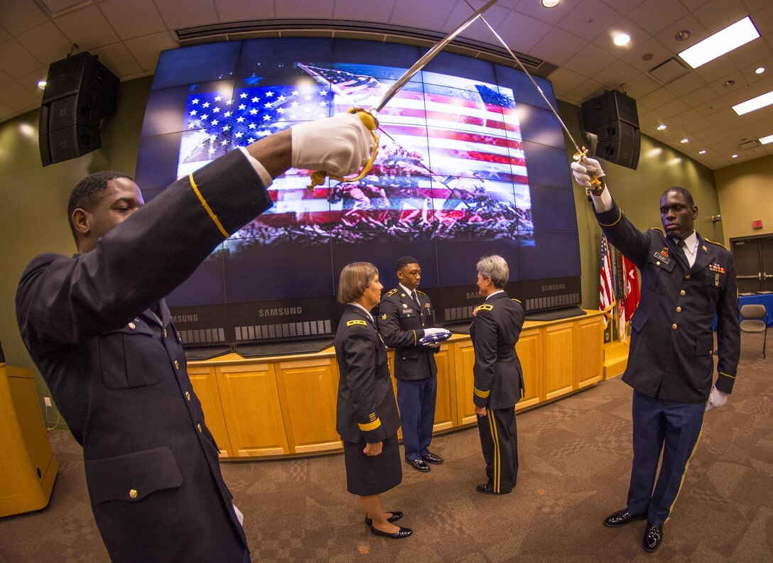 U.S. Army Reserve Brig. Gen. Janice M. Haigler (back to camera), deputy commanding general of the 335th Signal Command (Theater), salutes as she is presented an American flag during her retirement ceremony as Maj. Gen. Janet Lynn Cobb (in skirt), commander of the 81st Regional Support Command, looks on at Fort Jackson, S.C., July 16, 2016. Haigler’s distinguished career in the Army included multiple deployments in support of Operation Desert Storm, Operation Enduring Freedom, and Operation Iraqi Freedom. She was retiring after devoting 32 years of her life in service to her country. (U.S. Army photo by Staff Sgt. Ken Scar)