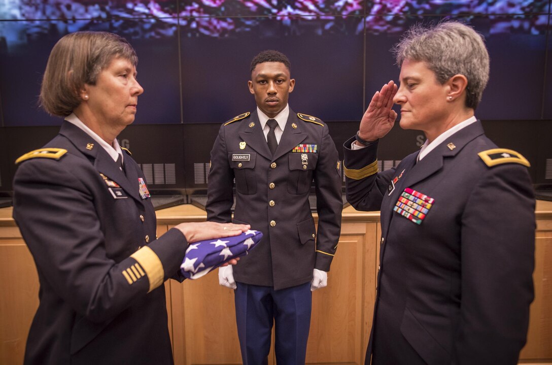 U.S. Army Reserve Brig. Gen. Janice M. Haigler (right), deputy commanding general of the 335th Signal Command (Theater), salutes as Maj. Gen. Janet Lynn Cobb, commander of the 81st Regional Support Command, presents her an American flag during her retirement ceremony at Fort Jackson, S.C., July 16, 2016. (U.S. Army photo by Staff Sgt. Ken Scar)