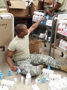 Spc. Markel Huff, a pharmacy technician from Company A, 48th Combat Support Hospital out of Fort Story, Va., helps to set up the pharmacy in preparation for Greater Chenango Cares July 14, 2016. Greater Chenango Cares is one of the Innovative Readiness Training missions which provides real-world training in a joint civil-military environment while delivering world-class medical care to the people of Chenango County, N.Y., from July 15-24.