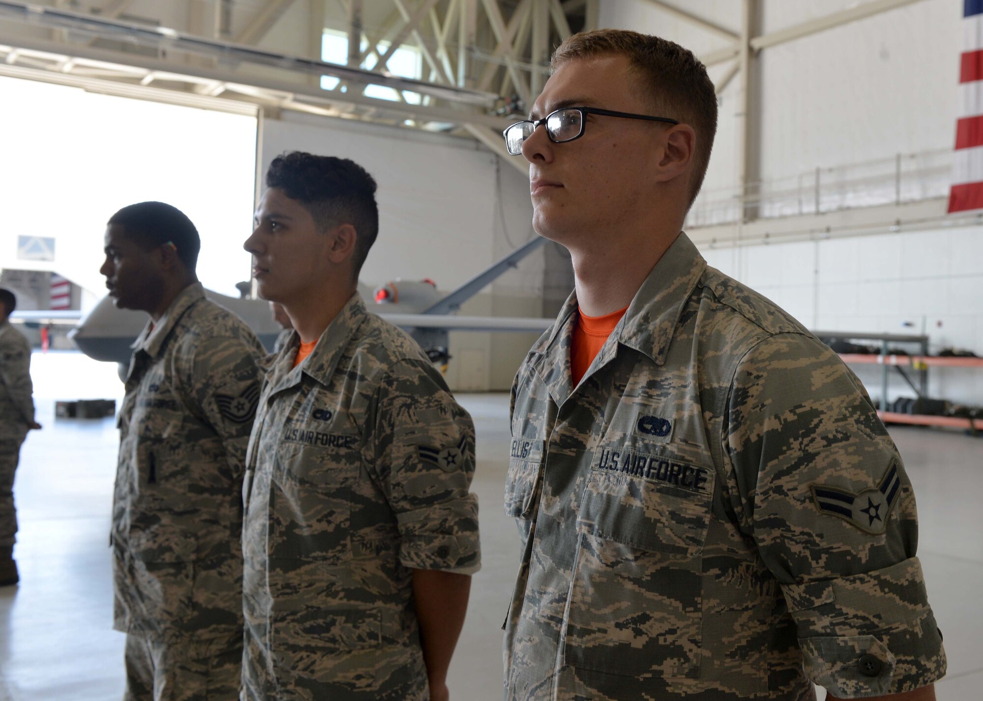 Airmen from the 432nd Aircraft Maintenance Squadron stand at parade rest during the Load Crew of the Quarter competition July 1, 2016, at Creech Air Force Base, Nevada. Load competitions such as this are an integral part of tradition and promote camaraderie throughout the 432nd AMXS. (U.S. Air Force photo by Airman 1st Class Kristan Campbell/Released)
