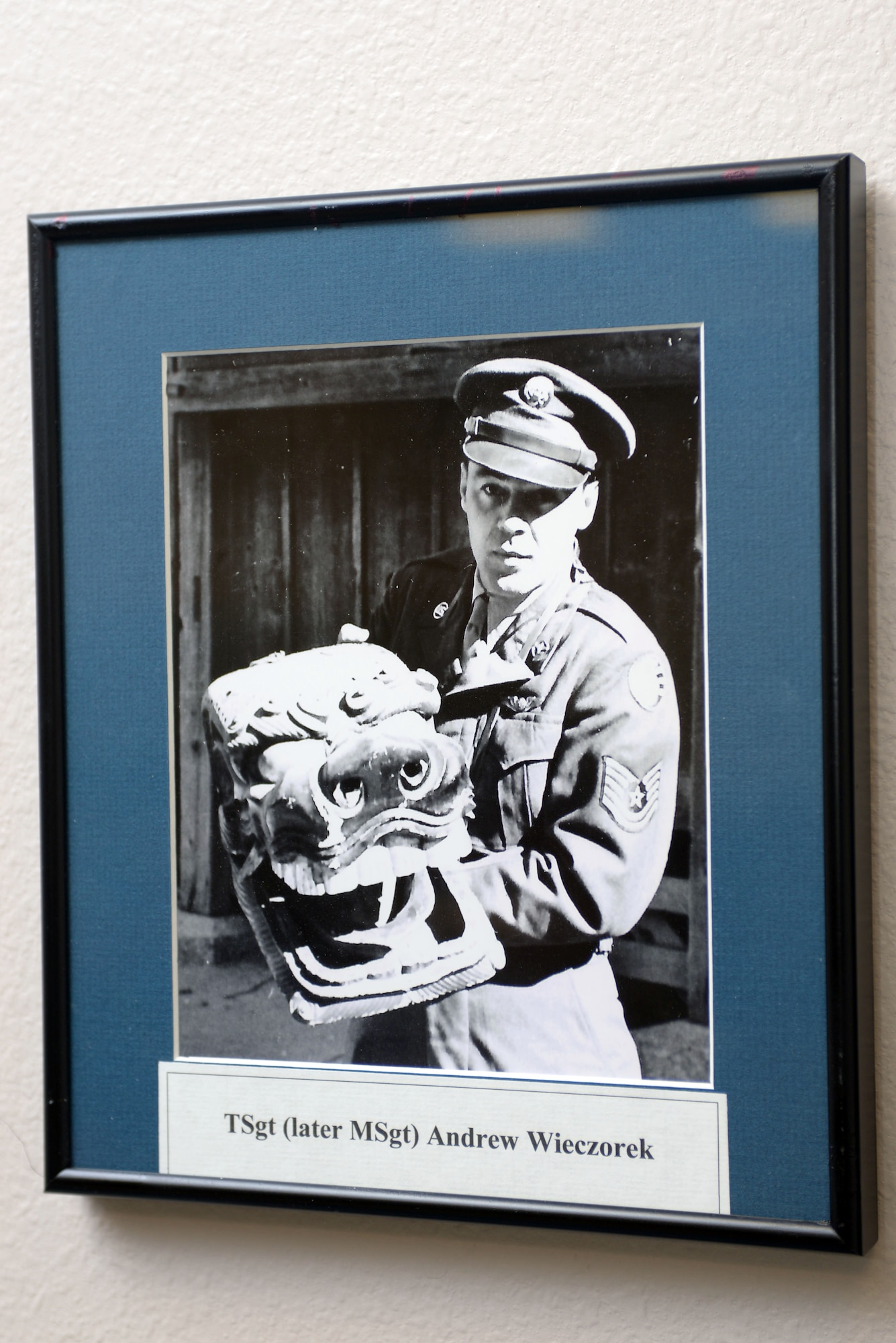 A portrait of Andrew Wieczorek, retired U.S. Air Force Master Sgt., is displayed in the 37th Bomb Squadron at Ellsworth Air Force Base, S.D., July 14, 2016. The portrait is displayed with a painting he made, known as “Lady Eve,” of a B-26 Marauder of the same name whose nose art he had painted 50 years earlier.  (U.S. Air Force photo by Airman Donald Knechtel/Released) 