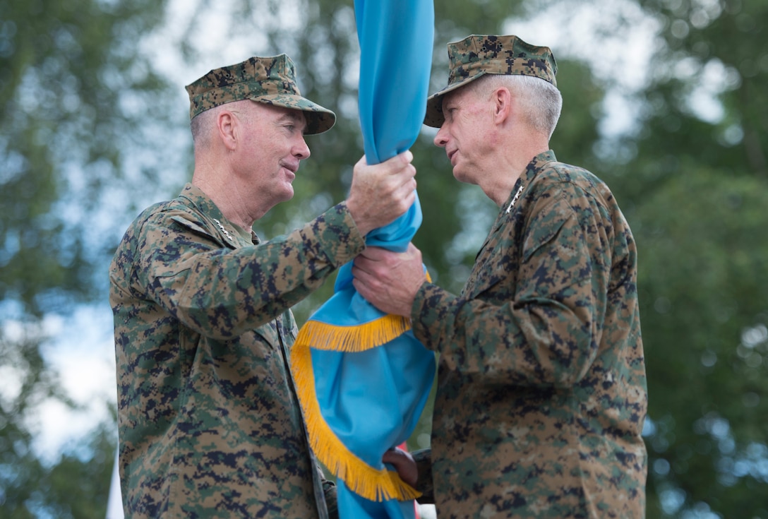 Marine Corps Gen. Joe Dunford, chairman of the Joint Chiefs of Staff, left, passes the U.S. Africa Command flag to Marine Corps Gen. Thomas D. Waldhauser, incoming commander of Africom, during the Africom change of command ceremony at U.S. Army Garrison Stuttgart, Germany, July 18, 2016. Waldhauser assumed command from Army Gen. David M. Rodriguez, who will retire after 40 years of military service. DoD photo by Navy Petty Officer 2nd Class Dominique A. Pineiro