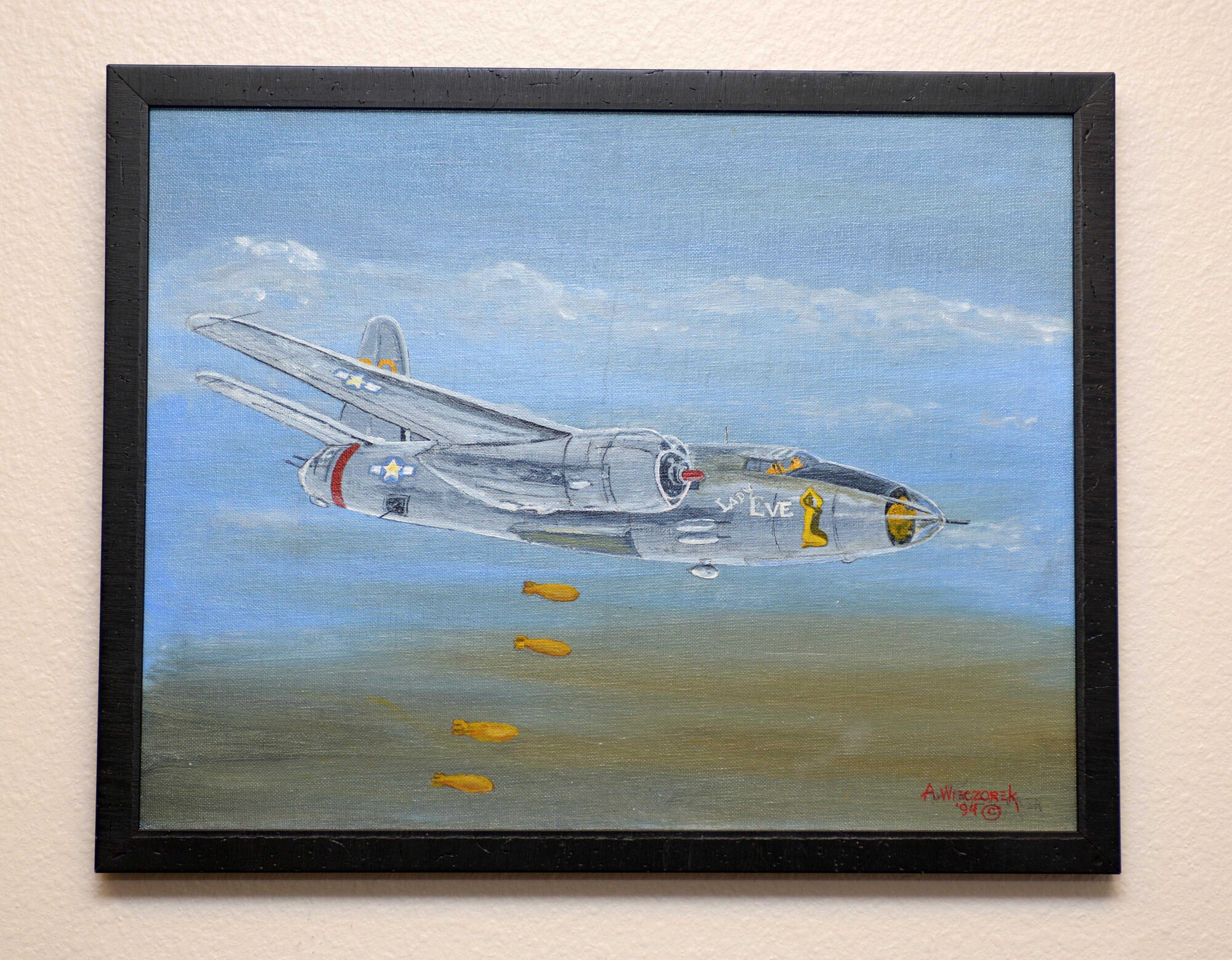 “Lady Eve,” a painting by Andrew Wieczorek, retired U.S. Air Force Master Sgt., hangs in the 37th Bomb Squadron at Ellsworth Air Force Base, S.D., July 14, 2016. Wieczorek, served as a ground crew member in the 37th BS with the U.S Army Air Corps, and was selected to paint nose art onto a B-26 Marauder known as the Lady Eve. The painting he created over five decades later of the aircraft was gifted to his old squadron and is now an artifact of its heritage. (U.S. Air Force photo by Airman Donald Knechtel/Released) 
