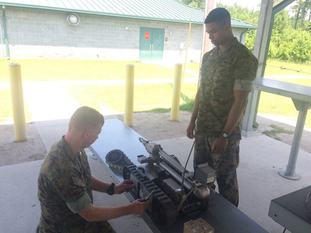 Second Lieutenants Nicholas Downey (left) and Aaron Graham, Marines, attached to Combat Engineer Officer course 5-16 (CEO 5-16), prepare to use a robot at Marine Corps Engineer School aboard Camp Lejeune, N.C., July 6, 2016. Robots are used to help identify, remove and subsequently reduce explosive hazards.

