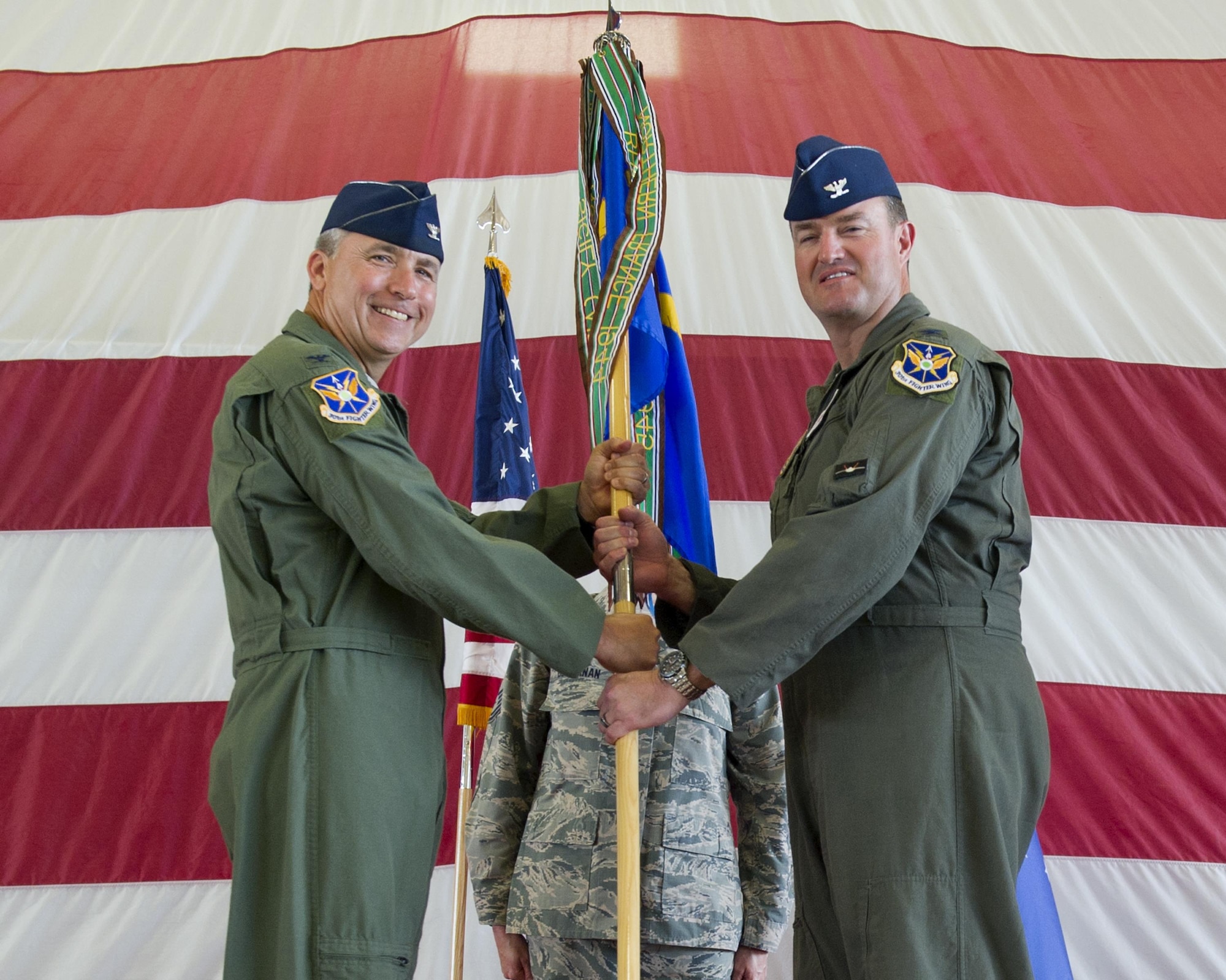 U.S. Air Force Col. John M. Breazeale, 301st Fighter Wing commander (left), presents the 44th Fighter Group guidon to its new commander, Col. Randall W. Cason during the 44th Fighter Group Change of Command Ceremony at Tyndall Air Force Base July 9. Cason was the commander of the 301st Fighter Squadron before taking the helm of the 44th FG. The 44th FG accomplishes Total Force Integration providing pilots, maintainers and support personnel in partnership with the 325th Fighter Wing to execute the Tyndall mission to train and project unrivaled combat air power. (U.S. Air Force photo by Senior Airman Alex Fox Echols III/Released)
