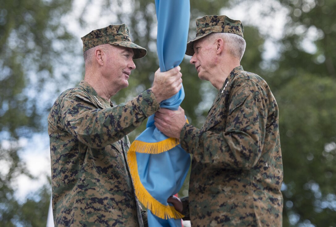 Marine Corps Gen. Joe Dunford, chairman of the Joint Chiefs of Staff, passes the U.S. Africa Command flag to Marine Corps Gen. Thomas D. Waldhauser, the command's incoming commander, during a ceremony at U.S. Army Garrison Stuttgart, Germany, July 18, 2016. Waldhauser assumed command from Army Gen. David M. Rodriguez, who will retire after 40 years of military service. Waldhauser is the command's first Marine commander and the fourth commander overall. DoD Photo by Navy Petty Officer 2nd Class Dominique A. Pineiro