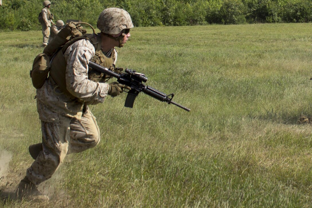 A Marine from Guard Company, Marine Barracks Washington, D.C., conducts a fire and maneuver drill during a field training exercise at Marine Corps Base Quantico, Va., July 13, 2016.  Marines with Guard Co. regularly execute these training iterations to hone their combat marksmanship and infantry skills. (Official Marine Corps photo by Lance Cpl. Micah Gann/Released)