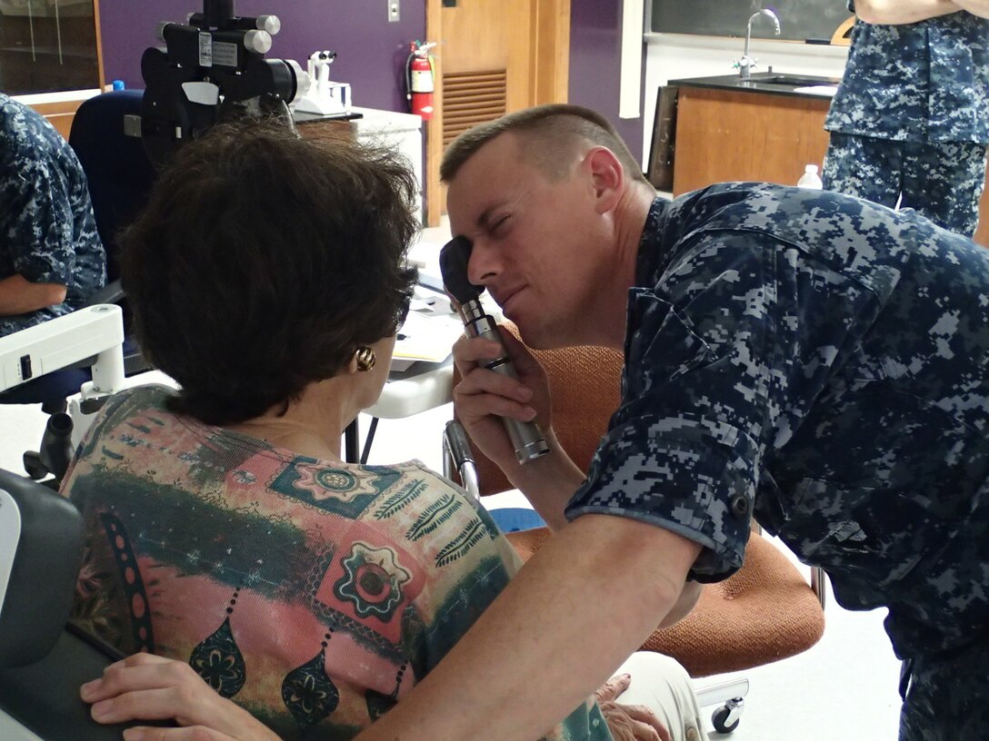 Lt. John Vingoe, an optometrist from the Naval Branch Health Clinic, Groton, Conn., conducts an eye exam on a patient during Greater Chenango Cares on July 15, 2016.  Greater Chenango Cares is one of the Innovative Readiness Training missions which provides real-world training in a joint civil-military environment while delivering world class medical care to the people of Chenango County, N.Y., from July 15-24.