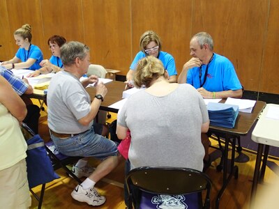 United Way volunteers assist patients in checking in during Greater Chenango Cares on July 15, 2016.  Greater Chenango Cares is one of the Innovative Readiness Training missions which provides real-world training in a joint civil-military environment while delivering world class medical care to the people of Chenango County, N.Y., from July 15-24.