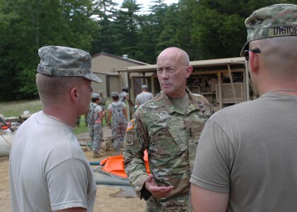 Lieutenant General Charles D. Luckey, chief of Army Reserve and commanding general, U.S. Army Reserve Command, visits Joint Base McGuire-Dix-Lakehurst, New Jersey, for a training-capabilities update July 14-15. The commanding general talks to New Jersey Army National Guard Soldiers of the 154th Quartermaster Company conducting water purification training at the U.S. Army Support Activity, Fort Dix training area known as Brindle Lake.