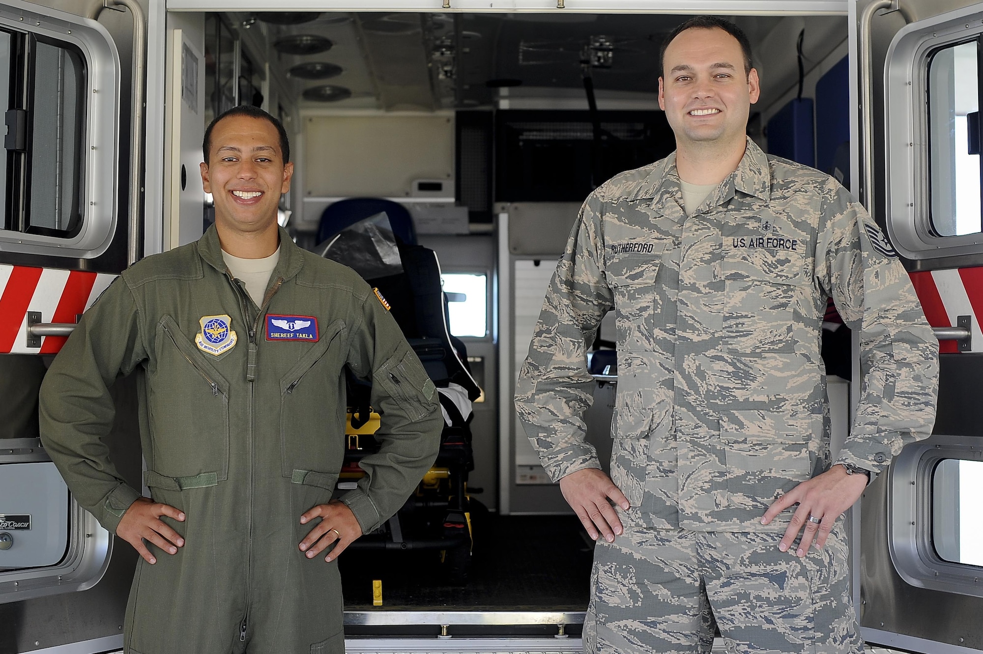 Capt. Shereef Takla, left, a flight surgeon assigned to the 6th Aerospace Medical Squadron, and Tech. Sgt Clark Rutherford, right, a flight aerospace medical technician assigned to the 91st Air Refueling Squadron, pose for a photo in front of an ambulance at the MacDill Air Force Base, Fla. medical clinic, July 14, 2016. Both Takla and Rutherford are responsible for the medical care of flying Airmen. (U.S. Air Force photo by Airman 1st Class Mariette Adams)