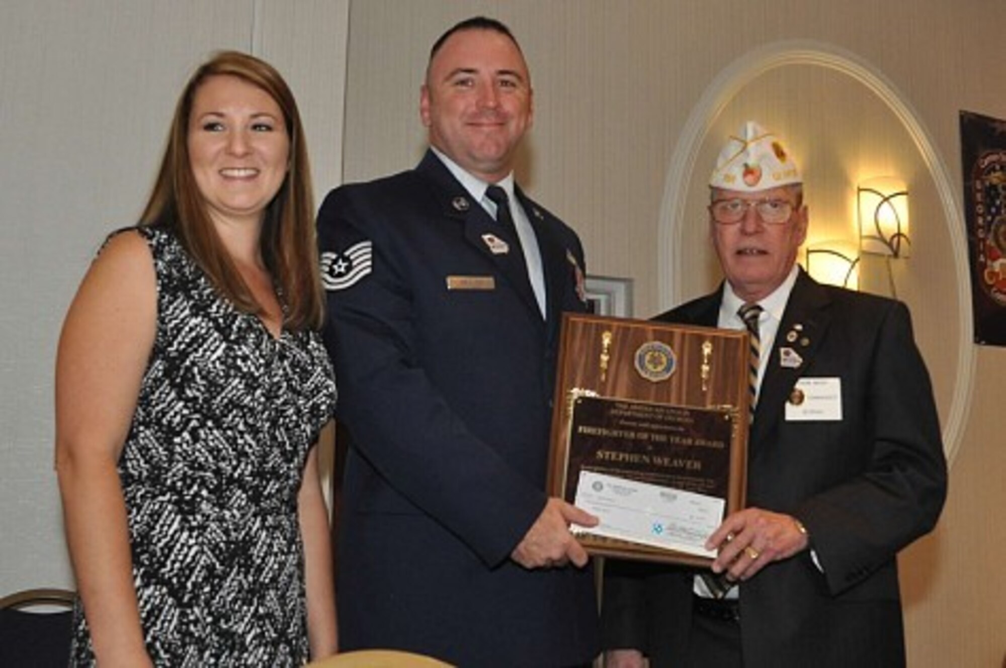 U.S. Air Force Tech. Sgt. Stephen Weaver, 23d Civil Engineer Squadron fire protection station chief, and his wife, Courtney, receive the American Legion’s Georgia firefighter of the year award from Thomas Nash, American Legion state commander, June 25, 2016, in Duluth, Ga. Weaver’s served in various leadership positions to include fire protection station chief, rescue air mobility squad team member, training manager, mobility manager and education advisor for 27 Personnel. (courtesy photo)