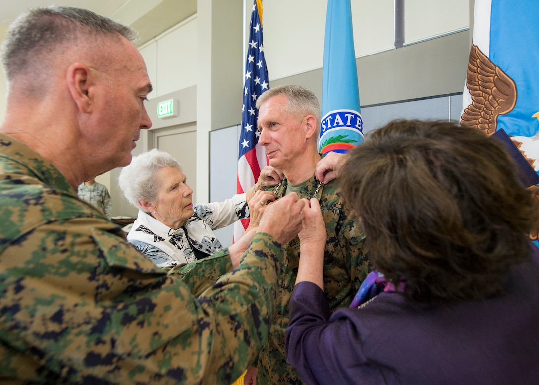 Marine Corps Gen. Joe Dunford, left, chairman of the Joint Chiefs of Staff, participates in the promotion of Marine Corps Gen. Thomas D. Waldhauser to general during a ceremony at Patch Barracks, U.S. Army Garrison Stuttgart, Germany, July 18, 2016. Waldhauser's wife, right, and his mother, second from left, participated in the pinning. Waldhauser assumed command from Army Gen. David M. Rodriguez, who will retire after 40 years of military service. Waldhauser is the first Marine Africom commander and the fourth commander overall. DoD photo by Navy Petty Officer 2nd Class Dominique A. Pineiro