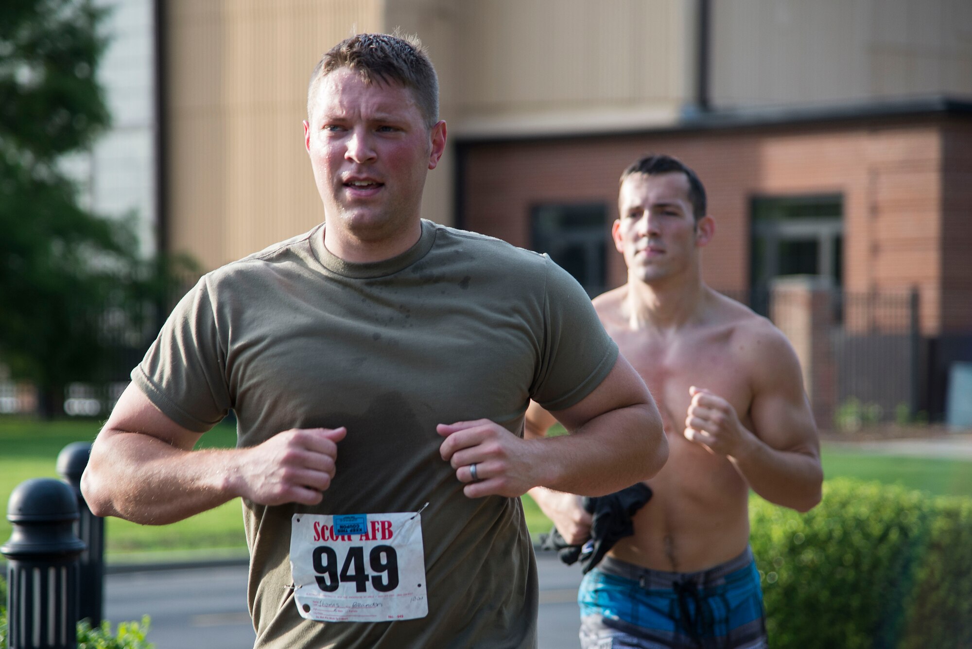 Senior Airman Brandon Thomas (left), 375th Civil Engineer Squadron, and another Team Scott Member compete in the “Splash N Dash” biathlon at Scott Air Force Base, Illinois, July 15, 2016. The biathlon required members to complete a 300 meter swim followed by a three mile run. Robert Wieland had the fastest time in the male category, 24 minutes 44 seconds, while Kimberly Wendt had the fastest time in the female category, 33 minutes 31 seconds. (U.S. Air Force photo by Tech. Sgt. Jonathan Fowler)