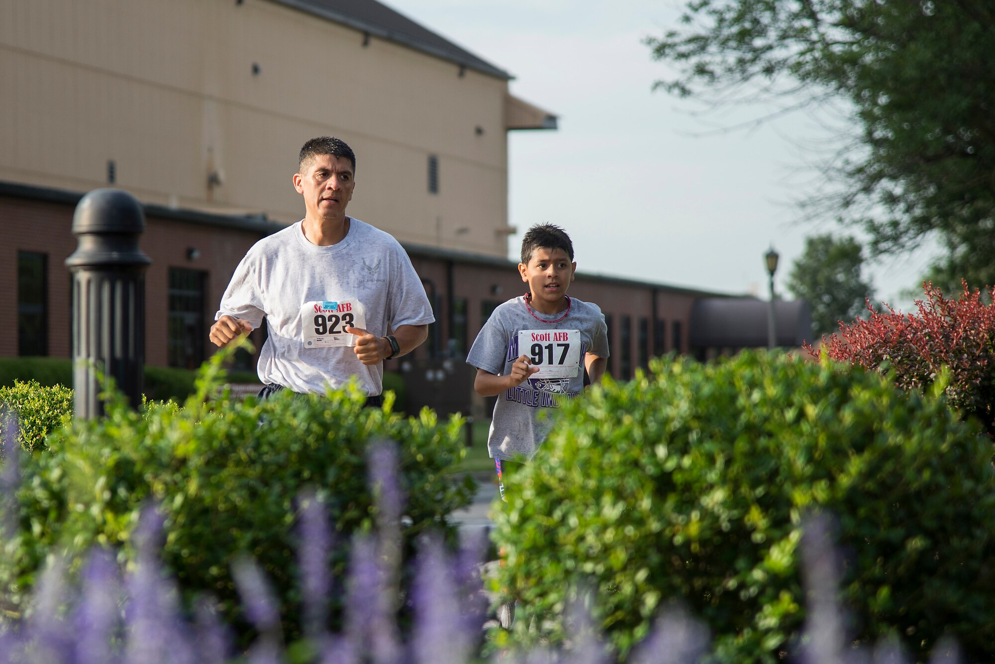 Command Chief Master Sgt. Benjamin Miranda Jr., 635th Supply Chain Operations Wing, and his son compete in the “Splash N Dash” biathlon at Scott Air Force Base, Illinois, July 15, 2016. The biathlon required members to complete a 300 meter swim followed by a three mile run. Robert Wieland had the fastest time in the male category, 24 minutes 44 seconds, while Kimberly Wendt had the fastest time in the female category, 33 minutes 31 seconds. (U.S. Air Force photo by Tech. Sgt. Jonathan Fowler)