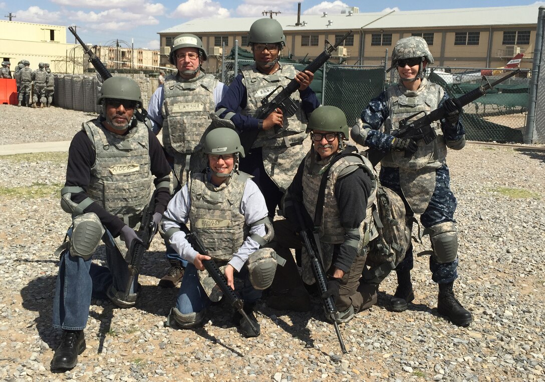 Navy Lt. j.g. Amy Aguirre (right), participated in Warrior Task Training with other Defense Contract Management Agency personnel at Operational Contract Support Joint Exercise 2015 held at Fort Bliss, Texas. Training consisted of convoy simulation, first aide, Humvee rollover training, room clearance and weapons qualification.
