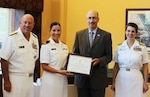 Navy Lt. j.g. Amy Aguirre (second from left, pictured as an Ensign), receives the Military Officers Association of America Professionalism Award in 2014 while attending the active duty Basic Qualification Course at the Navy Supply Corps School in Newport, R.I. Formerly a Navy Reserve Supply Corps Officer assigned to the Defense Contract Management Agency, Aguirre is one of three female reserve officers competitively selected to be recalled to active duty and serve in the Reserve Women in Submarines program.