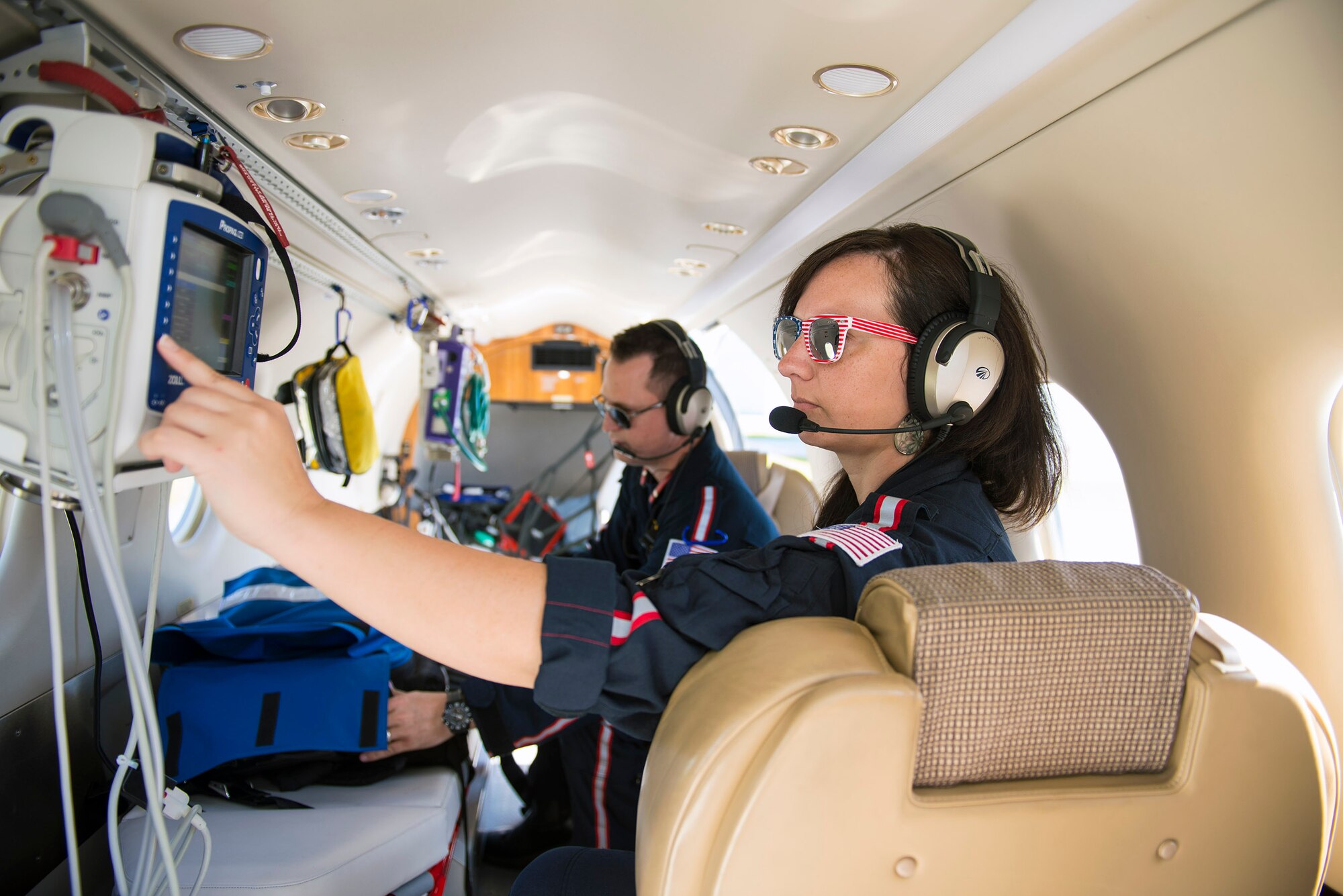 Air Medical Service members Stephanie Sapp, flight nurse, right, and Zachary Nicholson, flight paramedic, perform a daily check during a pre-flight assessment at a local airport, July 13, 2016, in Valdosta, Ga. Their responsibilities are to provide emergent medical care as U.S. Air Force Master Sgt. Rusty Harrell, 476th Fighter Group career assistance advisor and civilian medic pilot, aerially lifts patients to ambulatory care across the southeastern United States. (U.S. Air Force photo by Airman 1st Class Greg Nash)