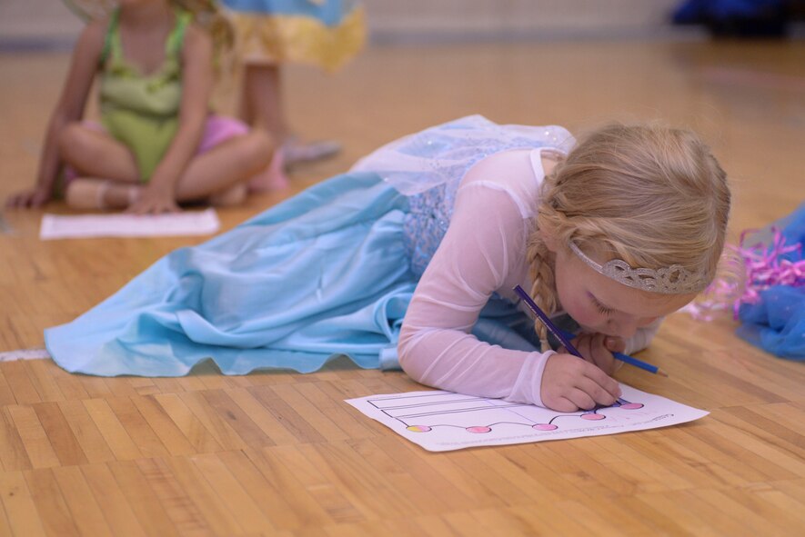 Military child Julia Messerly colors a crown during Princess Dance Camp at the Youth Center at Minot Air Force Base, N.D., June 29, 2016. Students colored crowns while the instructor read stories of Disney princesses. (U.S. Air Force photo/Airman 1st Class Jessica Weissman)