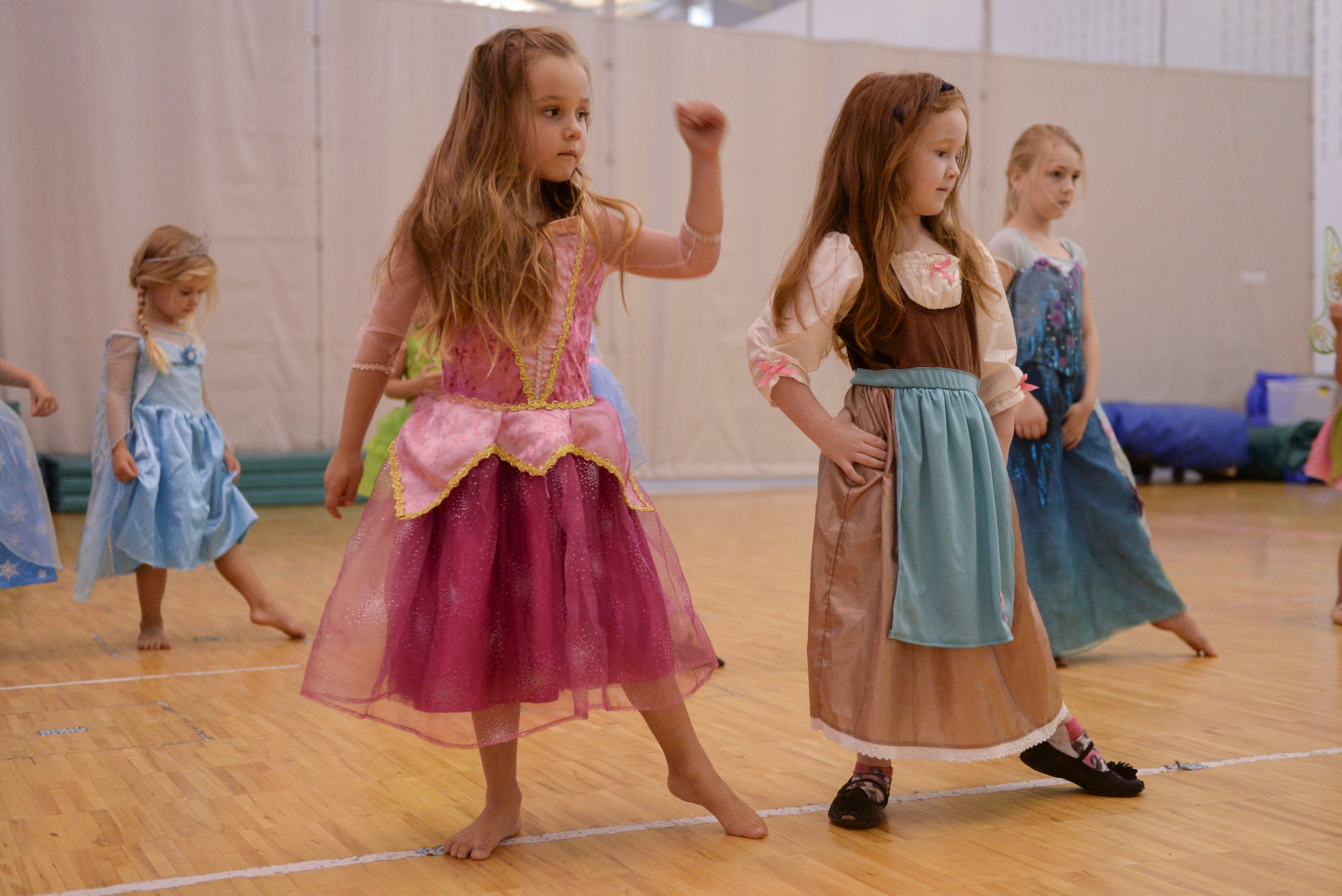Military children Aubrey Moscato and Maggie Cutler preform a tendu during Princess Dance Camp at Minot Air Force Base, N.D., June 29, 2016. Students were taught basic instructions for beginner ballet though the week-long course offered by the youth center. (U.S. Air Force photo/Airman 1st Class Jessica Weissman)