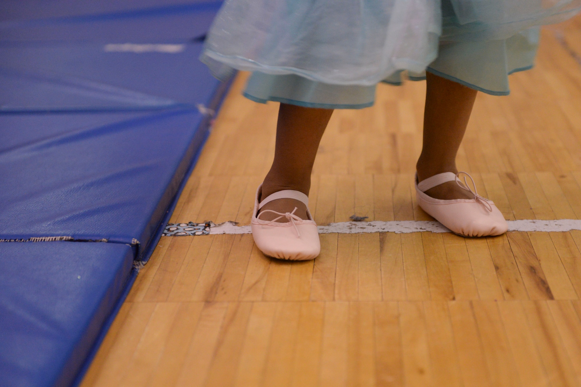 A young girl from the Youth Center at Minot Air Force Base, N.D., stands during Princess Dance Camp, June 29, 2016. Students were taught basic instructions for ballet, such as positions, pirouettes and stretching. (U.S. Air Force photo/Airman 1st Class Jessica Weissman)