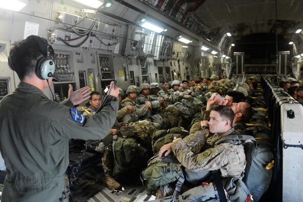 Air Force Staff Sgt. Donovan Eliopulos, of the 7th Airlift Squadron, briefs Soldiers from the 82nd Airborne Divison on egress procedures aboard a C-17 Globemaster III from Joint Base Lewis-McChord, Wash., during battalion mass tactical week at Pope Army Airfield, N.C., July 12, 2016. During the exercise, Army and Air Force units worked together to improve interoperability for worldwide crisis, contingency and humanitarian operations. (U.S. Air Force photo/Staff Sgt. Sandra Welch)
