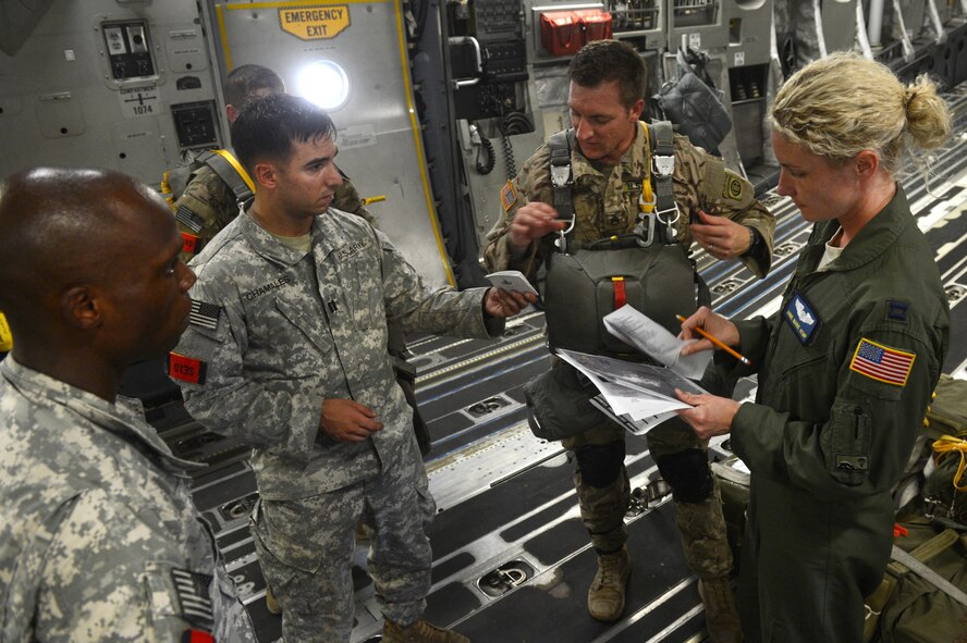 Airmen from Joint Base Lewis-McChord, Wash., and Soldiers from the 82nd Airborne Division conduct a pre-mission brief inside of a C-17 Globemaster III before conducting static line drops on Sicily Drop Zone during the battalion mass tactical week at Pope Army Airfield, N.C., July 12, 2016. During the exercise, Army and Air Force units worked together to improve interoperability for worldwide crisis, contingency and humanitarian operations. (U.S. Air Force photo/Staff Sgt. Sandra Welch)