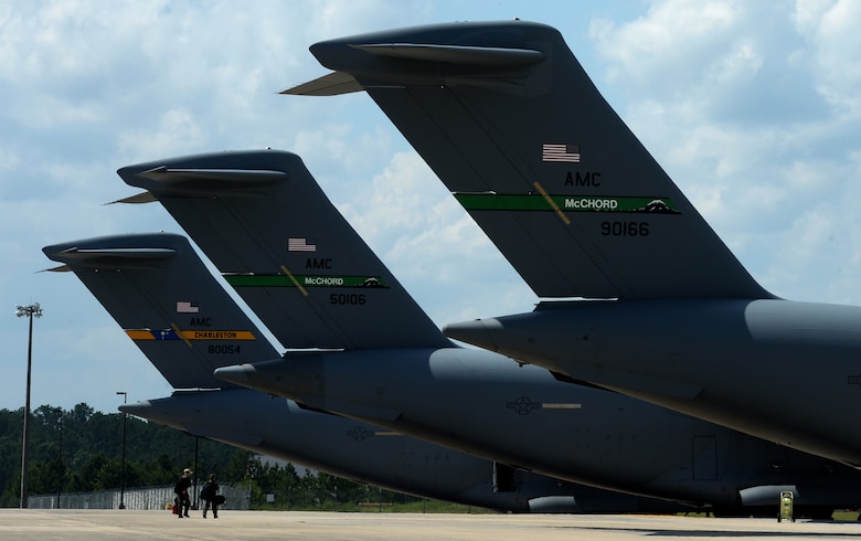 Three C-17 Globemaster III aircraft stand ready to be loaded prior to a mass tactical parachute jump onto Sicily Drop Zone at Fort Bragg, N.C., July 12, 2016. During mass-tactical week the Army and Air Force units work together to improve interoperability for worldwide crisis, contingency and humanitarian. (U.S. Air Force photo by Senior Airman Ericka Engblom)