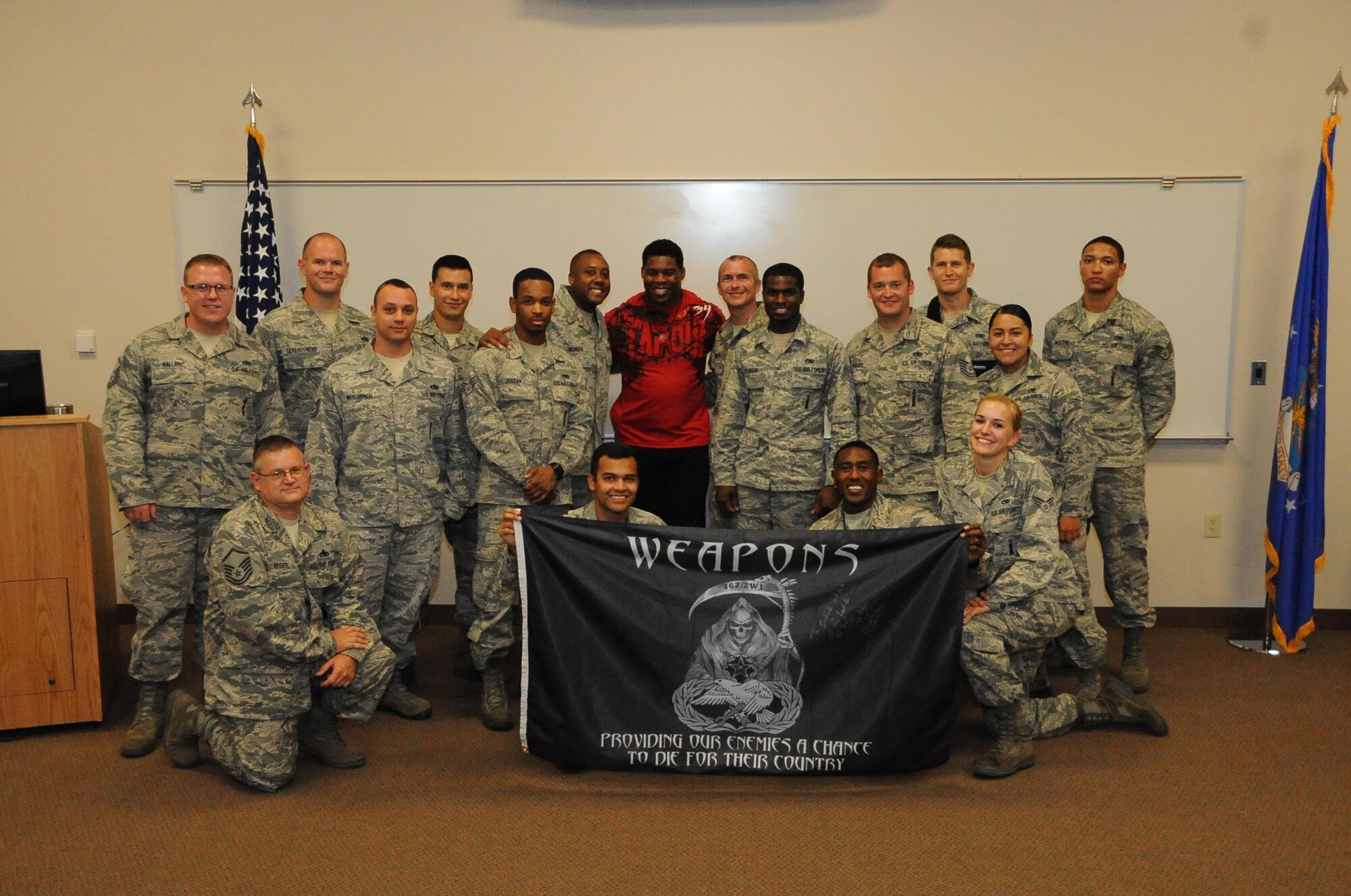 Herschel Walker, former NFL running back, poses for a photo with Airmen from the 2nd Operations Group at Barksdale Air Force Base, La., July 12, 2016. Walker visited Barksdale to tell Airmen his story about battling Dissociative Identity Disorder, a disease characterized by the presence of two or more distinct identities. (U.S. Air Force photo/Airman 1st Class Stuart Bright)