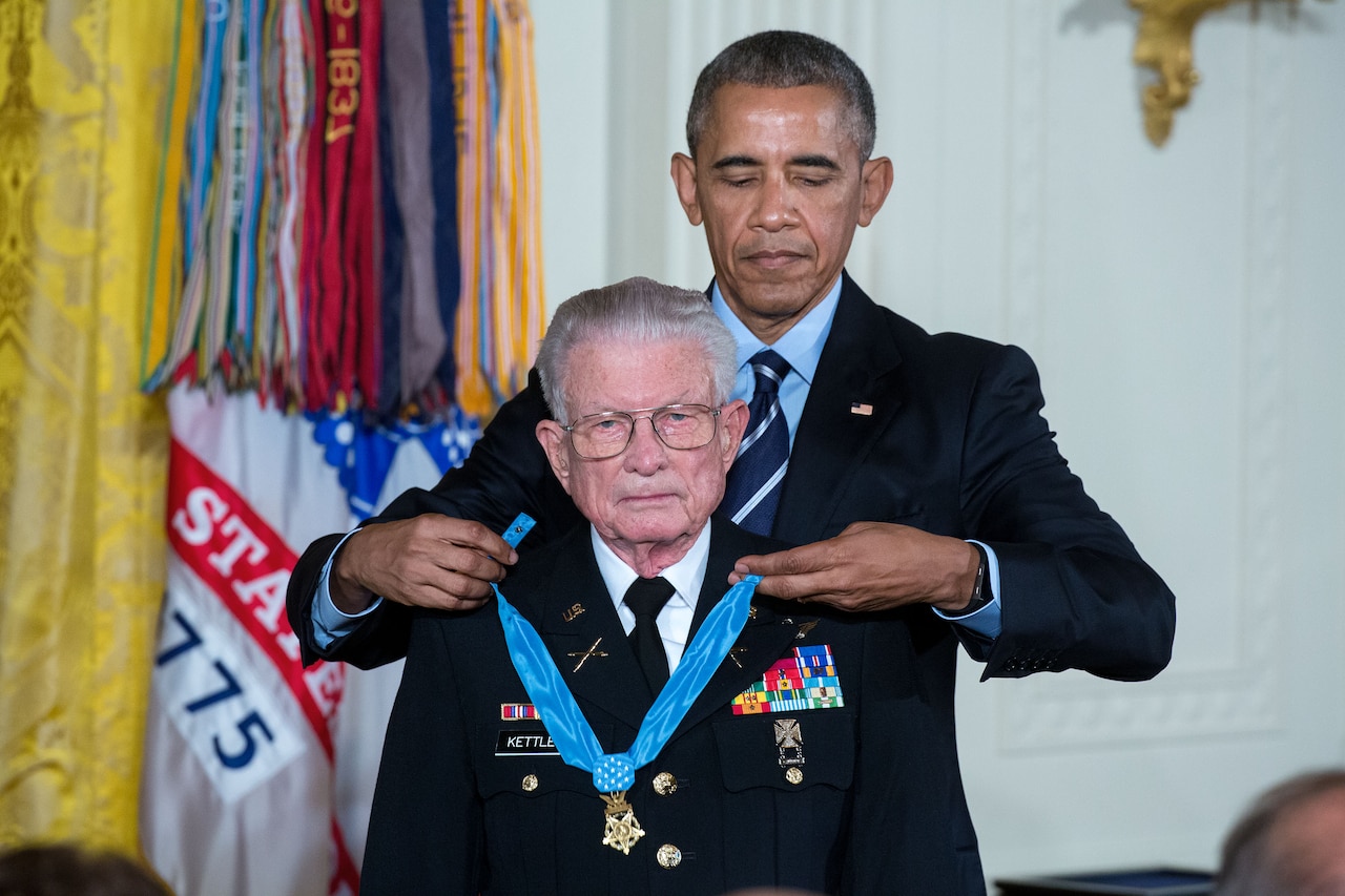 President Barack Obama presents the Medal of Honor to retired Army Lt. Col. Charles Kettles for conspicuous gallantry during a ceremony in the East Room of the White House, July 18, 2016. Then-Major Kettles distinguished himself in combat operations near Duc Pho, South Vietnam, on May 15, 1967, and is credited with saving the lives of 40 soldiers and four of his own crew members. White House photo by Chuck Kennedy