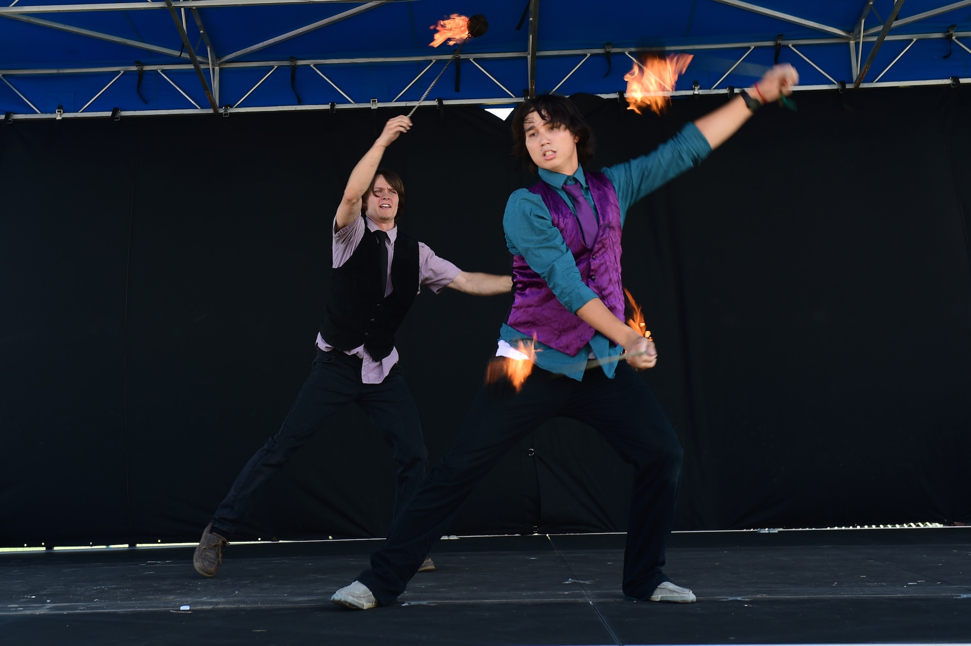 Tyler Chic and Xander Paris, Buckley Air Force Base youth, perform a fire-twirling routine July 15, 2016, during Diversity Day on Buckley Air Force Base, Colo. Diversity Day provided an opportunity to explore and celebrate the accomplishments and cultures of a diverse military force, which included food, dancing and music from various cultures. (U.S. Air Force photo by Airman 1st Class Gabrielle Spradling/Released)