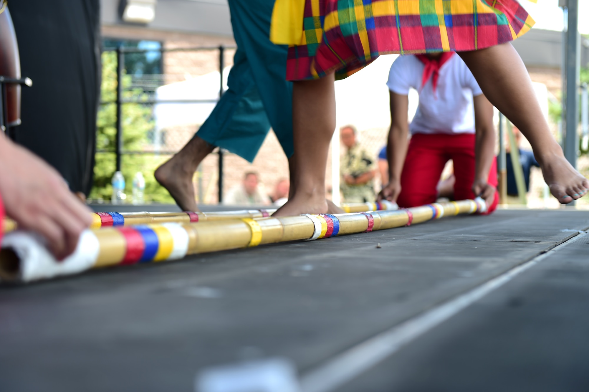 Philippine-American Society of Colorado members perform an authentic Philippine dance, known as tinikling, July 15, 2016, during Diversity Day on Buckley Air Force Base, Colo. Diversity Day provided an opportunity to explore and celebrate the accomplishments and cultures of a diverse military force, which included food, dancing and music from various cultures. (U.S. Air Force photo by Airman 1st Class Gabrielle Spradling/Released)