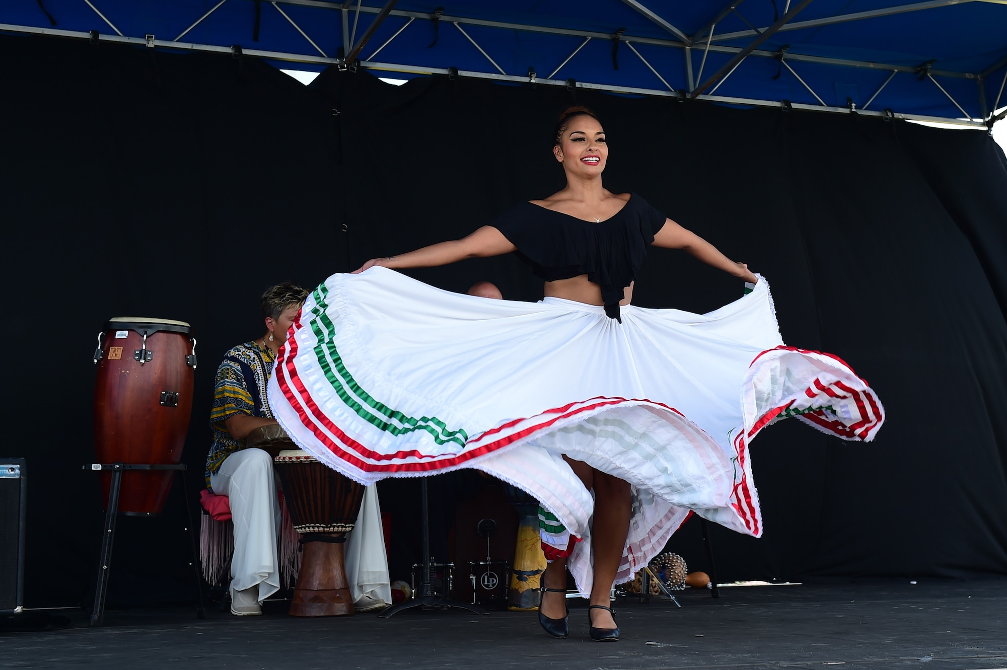 A member of the World Dance Show performs a routine July 15, 2016, during Diversity Day on Buckley Air Force Base, Colo. Diversity Day provided an opportunity to explore and celebrate the accomplishments and cultures of a diverse military force, which included food, dancing and music from various cultures. (U.S. Air Force photo by Airman 1st Class Gabrielle Spradling/Released)