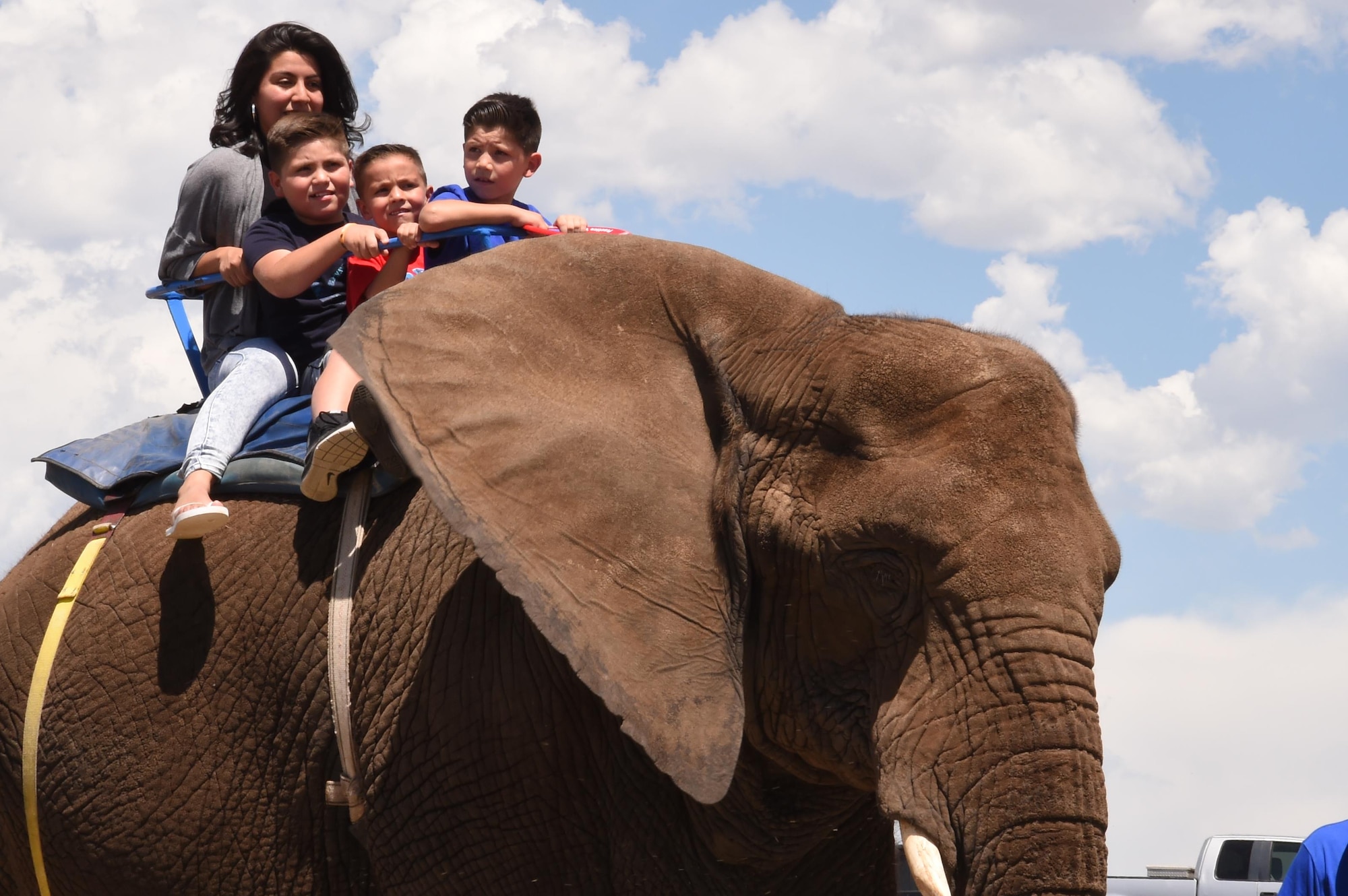 Jasmine Jaramillo, Elijah Lujan, Luciano Lujan and Elonzo Lujan ride an elephant during the Summer Slam Base Picnic at Schriever Air Force Base, Colorado, Friday, July 15, 2016. Several elephants and camels were brought to the picnic to give families rides. (U.S. Air Force photo/2nd Lt. Darren Domingo)