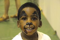 Camron Pressley smiles with his new puppy face painting during the Summer Slam Base Picnic at Schriever Air Force Base, Colorado, Friday, July 15, 2016. (U.S. Air Force photo/Airman William Tracy)