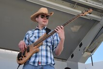 Senior Airman Jared Andrews, U.S. Air Force Academy Band bassist, plays a country tune during the Summer Slam Base Picnic at Schriever Air Force Base, Colorado, Friday, July 15, 2016. The band, Wild Blue Country, supports military and public functions with live music. (U.S. Air Force photo/2nd Lt. Darren Domingo)