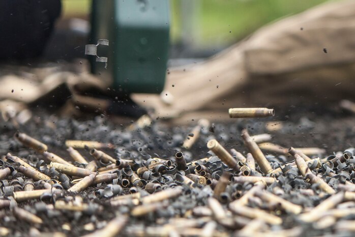 Brass casings fall to the ground while U.S. Marines with Marine Wing Support Squadron (MWSS) 171 stationed at Marine Corps Air Station Iwakuni, Japan, shoot on a machine-gun range during exercise Eagle Wrath 2016 at Combined Arms Training Center Camp Fuji, July 16, 2016. The annual exercise focuses on providing aviation-ground support to an assigned aviation combat element while reinforcing skills that Marines learned throughout their military occupational specialty schooling and Marine Combat Training. The squadron plans to complete their unit annual training requirements throughout three stages, which focus on air base ground defense and Marine Corps common skills that Marines are unable to train for locally. (U.S. Marine Corps photo by Lance Cpl. Aaron Henson)