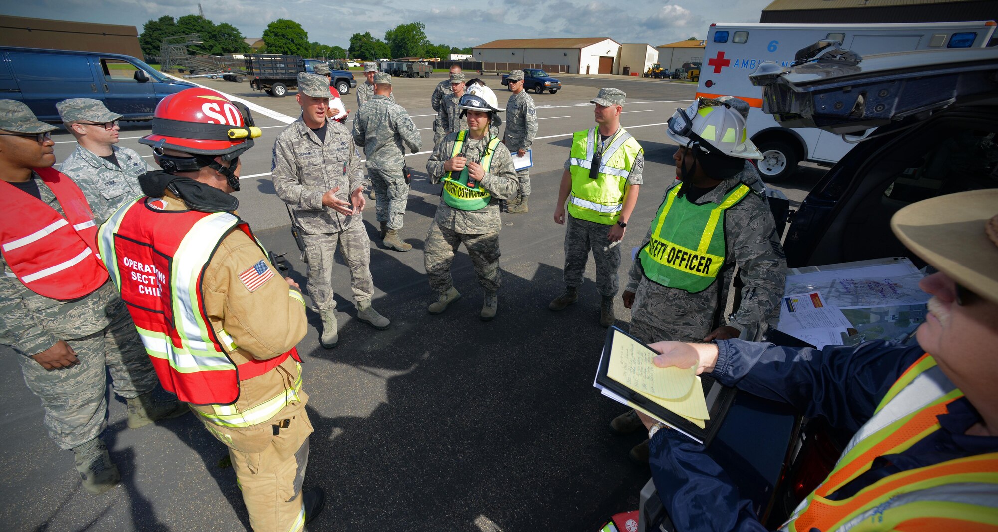 U.S. Air Force Airmen discuss a plan of action during an exercise July 16, 2016, on RAF Mildenhall, England. The exercise tested first responders during a simulated fuel spill. (U.S. Air Force photo by Senior Airman Christine Halan)