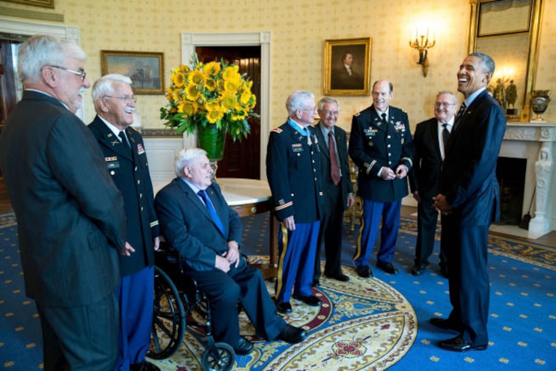 President Barack Obama talks with retired Army Lt. Col. Charles Kettles, center, and his guests, former brothers-in-arms from Vietnam, in the Blue Room following the Medal of Honor ceremony for Kettles at the White House in Washington D.C., July 18, 2016. Then-Major Kettles distinguished himself in combat operations near Duc Pho, South Vietnam, on May 15, 1967, and is credited with saving the lives of 40 soldiers and four of his own crew members. White House photo by Pete Souza