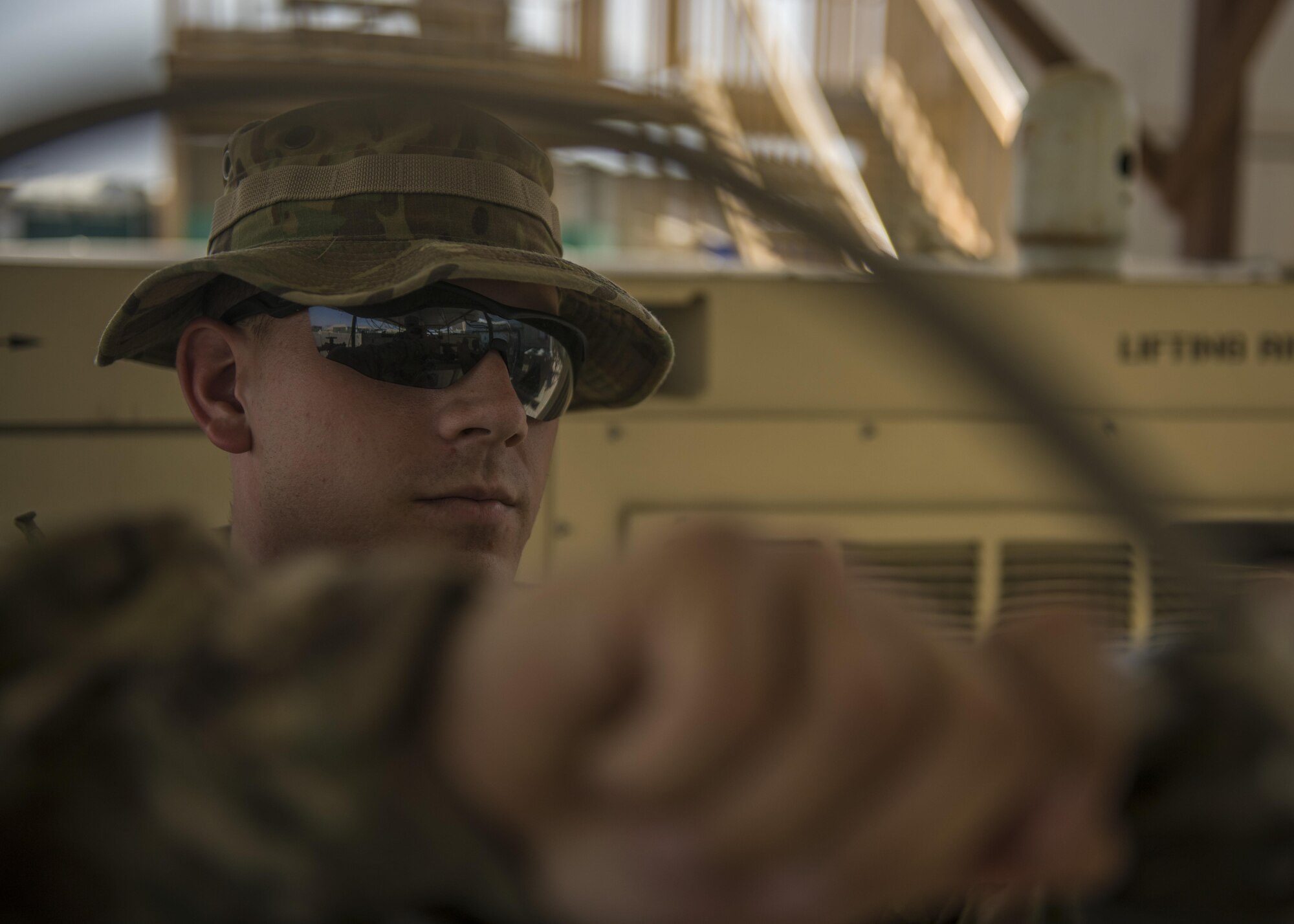 Staff Sgt. James Hughes, 455th Expeditionary Medical Group, biomedical equipment technician, turns the knob on an oxygen tank, Bagram Airfield, Afghanistan, July 18, 2016. Tanks are opened upon delivery, to ensure full potential of medical oxygen is released. (U.S. Air Force photo by Senior Airman Justyn M. Freeman)