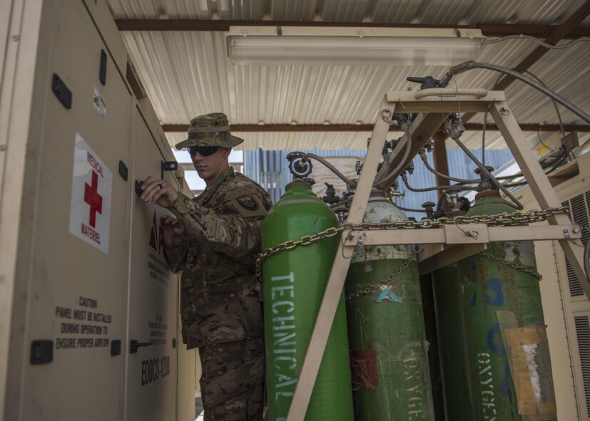 Staff Sgt. James Hughes, 455th Expeditionary Medical Group, biomedical equipment technician, checks an Expeditionary Deployable Oxygen Concentration System (EDOCS), Bagram Airfield, Afghanistan, July 18, 2016. The EDOCS take the outside air, filters out the nitrogen and carbon dioxide and delivers 93 percent of medical oxygen to the hospital during treatment. (U.S. Air Force photo by Senior Airman Justyn M. Freeman)