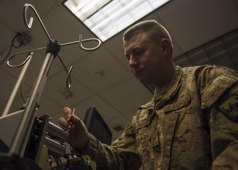 Staff Sgt. Alexander Stansbury, 455th Expeditionary Medical Group, bioenvironmental equipment technician, checks the voltage on a hemodialysis unit, Bagram Airfield, Afghanistan, July 18, 2016. Clinical engineers preform preventative maintenance to help maintain the sustainability of the hospital equipment and machinery. (U.S. Air Force photo by Senior Airman Justyn M. Freeman)
