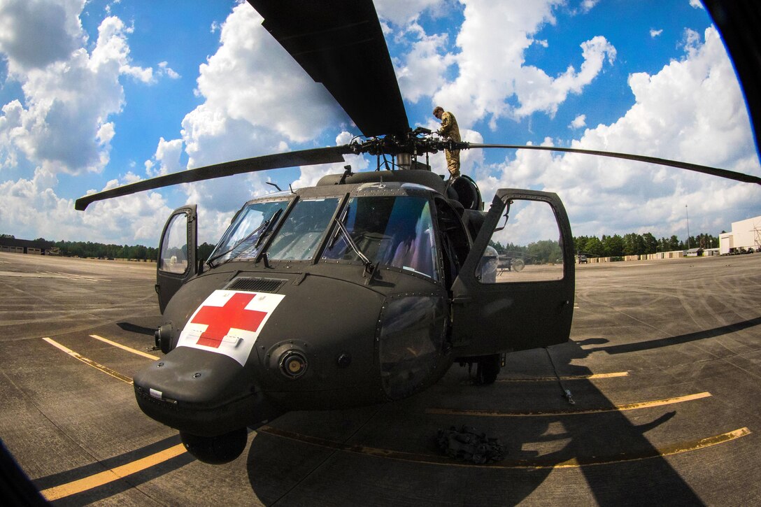 Army Capt. Daniel Prial inspects a UH-60 Black Hawk helicopter’s rotary blades before participating in a routine flight over Fort Bragg, N.C., July 12, 2016. Prial is a pilot assigned to the 3rd General Support Aviation Battalion. Army photo by Capt. Adan Cazarez